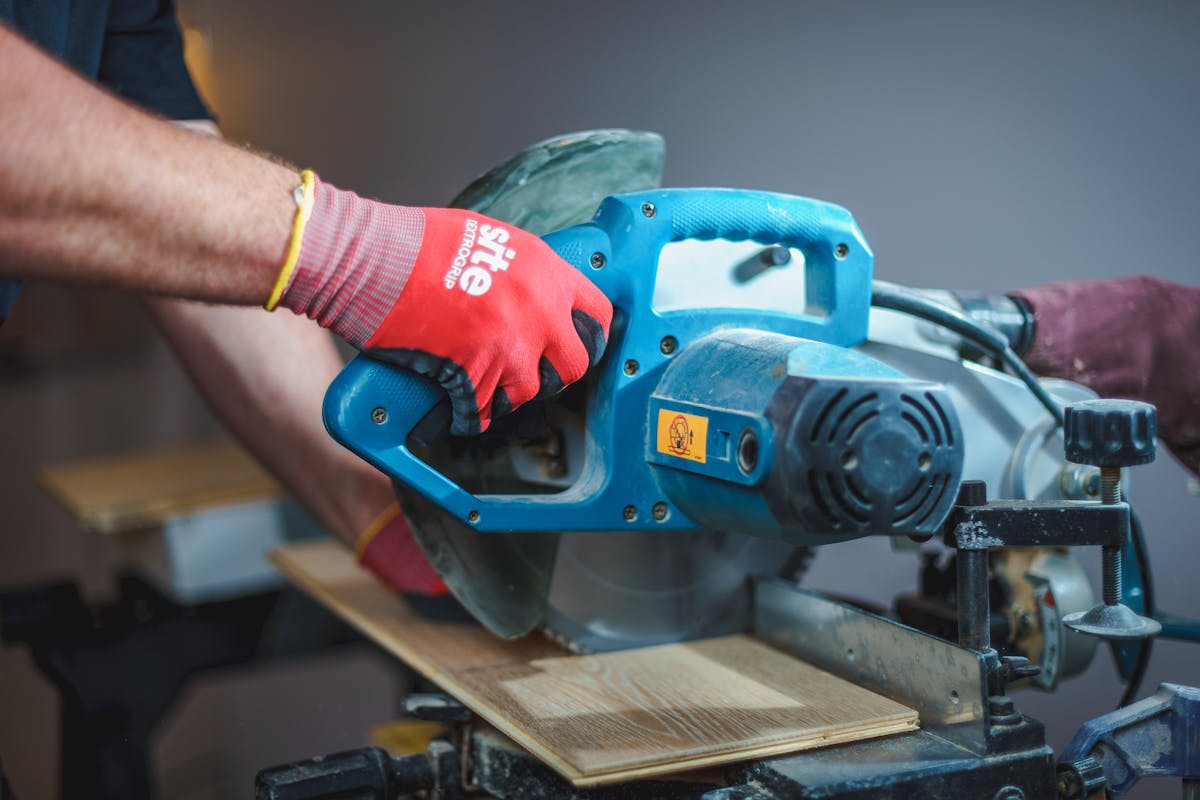Carpenter using a circular saw to cut a deck board on a weekend DIY build